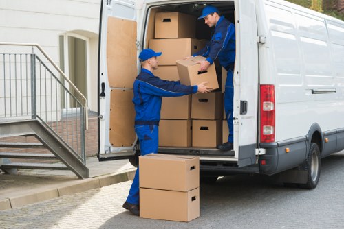 House removals service in Raynes Park with moving van near local homes