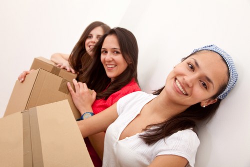 Packed office boxes and furniture ready for a local business move