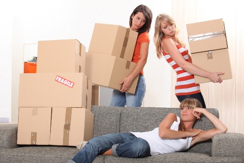 Office relocation equipment and desks being handled by movers